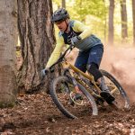 A man riding a mountain bike through a forest